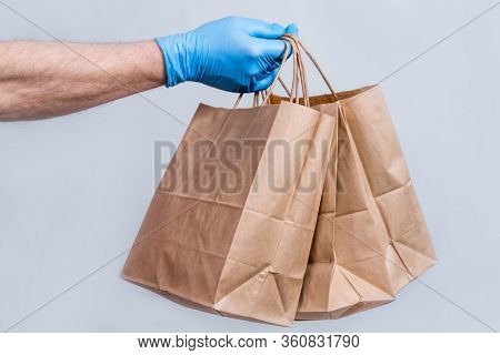 The Concept Of Safe Delivery In Close-up. The Couriers Hand In Protective Medical Gloves Holds A Pap