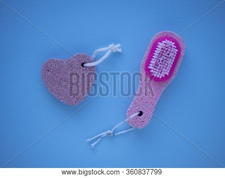 Pink Pumice With A Brush And Pumice In Heart Shape For Pedicure And Foot Care Isolated On A Blue Bac