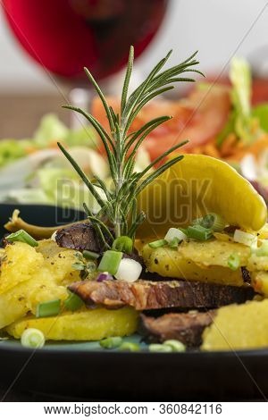 Closeup Of Austrian Potato Groestl With Red Wine