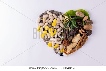 Top View Shot Of A Heart Made Of Ayurvedic Medicines With Herbs And Spices On White Background. Herb