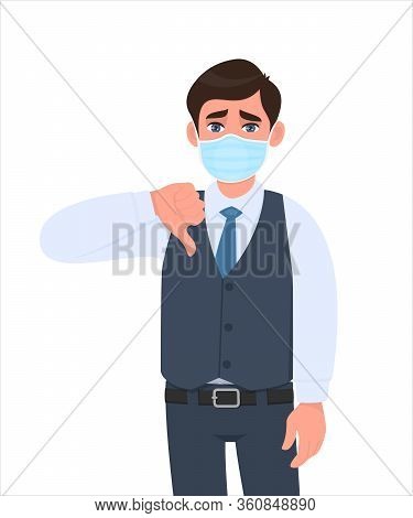 Unhappy Young Businessman Wearing Medical Mask And Showing Thumbs Down Sign. Trendy Person In Waistc