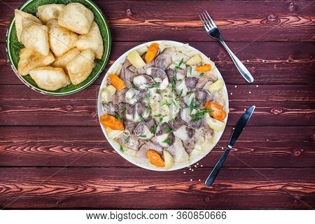 Beshbarmak Dish With Baursak - Traditional Kazakh Asia Food And National Bread. Noodles With Lamb An