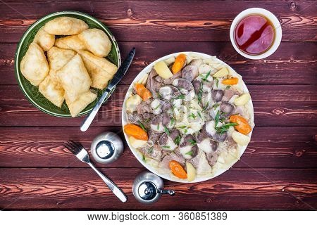 Beshbarmak Dish With Baursak - Traditional Kazakh Asia Food And National Bread. Noodles With Lamb An