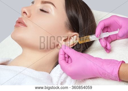 The Doctor Cosmetologist Makes The Injections Procedure For Smoothing Wrinkles And Against Flabbines