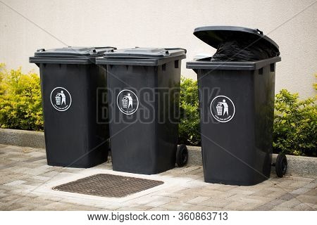 Black Indoor Waste Containers For Recycling And Garbage. A Lot Of Closed And Recycle Receptacles Tra