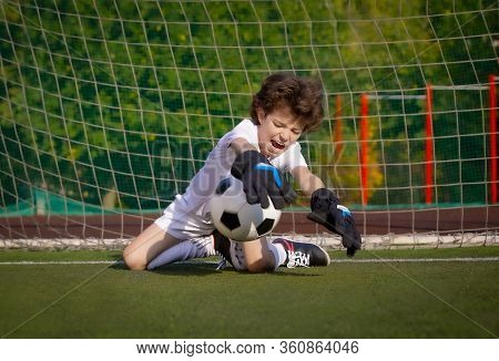 Summer Soccer Tournament For Young Kids. Football Club. Emotions And Joy Of The Game. Young Goalie. 