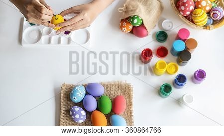 Top View Of Asian Woman Hand Painting Eggs For Eastertime At Home. Family Preparing For Easter.