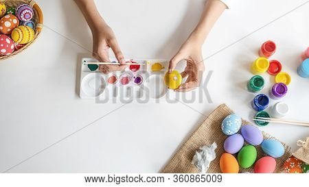Top View Of Asian Woman Hand Painting Eggs For Eastertime At Home. Family Preparing For Easter.