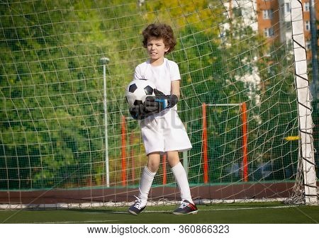 Summer Soccer Tournament For Young Kids. Football Club. Emotions And Joy Of The Game. Young Goalie. 