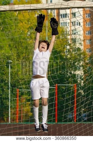 Summer Soccer Tournament For Young Kids. Football Club. Emotions And Joy Of The Game. Young Goalie. 