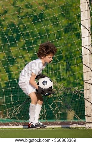 Summer Soccer Tournament For Young Kids. Football Club. Emotions And Joy Of The Game. Young Goalie. 