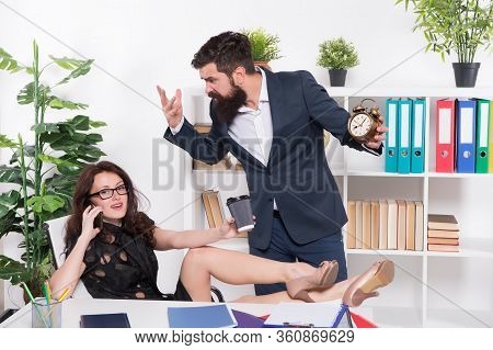 Its Not Proper Timing. Stressed Director Point At Clock While Manager Talk On Phone And Drink Coffee