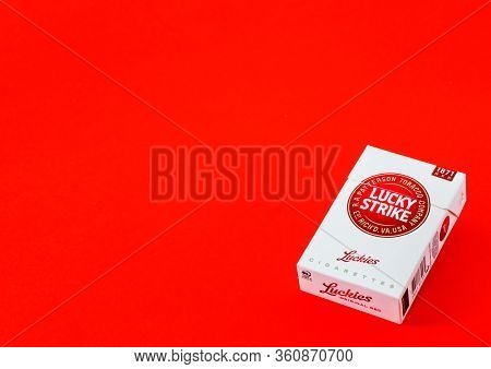 MOSCOW, RUSSIA - APRIL 04, 2020: Lucky strike cigarettes on a red background, copy space for text. Illustrative Editorial Photo