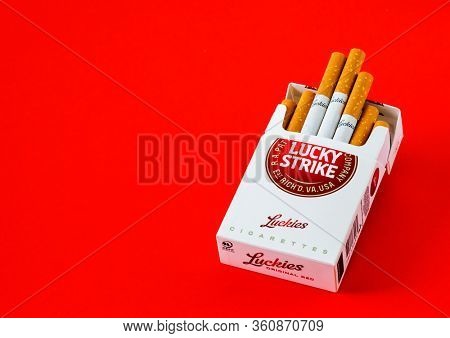MOSCOW, RUSSIA - APRIL 04, 2020: Lucky strike cigarettes on a red background, copy space for text. Illustrative Editorial Photo