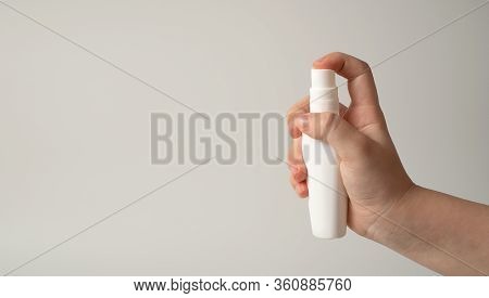 Hands Of The Child With A Disinfectant Solution To Protect Against Viruses, Bacteria. The Concept Of