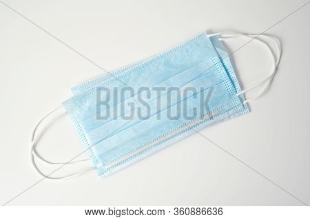 Blue Medical Protective Mask To Protect Against Viruses, Bacteria And Other Threats On A White Backg