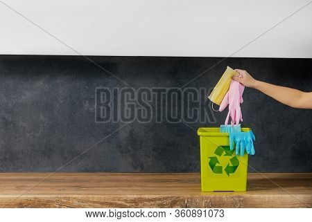 End Of Coronavirus Quarantine. A Female Hand Throws Used Face Masks And Gloves Into A Trash Can. Ret