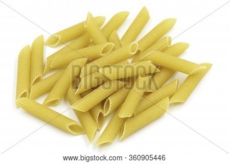 Homemade Penne Pasta Heap On White Isolated Background In Macro Top View. Penne Look Like Tube And H