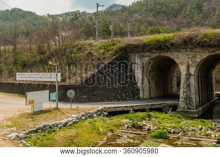 Hwanggan, South Korea; April 10, 2020: Arch Railroad Bridge With White Circles Marking Bullet Holes 