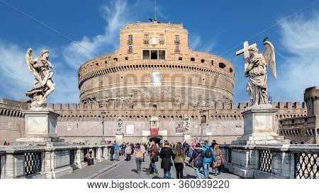 Rome, Italy - February 2015: Saint Angelo Castle And Tourists On The Bridge Over Tiber River. Built 
