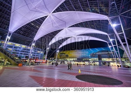 MUNICH, GERMANY - CIRCA JANUARY, 2020: view of the Munich Airport Center in the evening. The Munich Airport Center is a shopping, business, and recreation area that connects the terminals