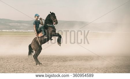 Kayseri, Turkey - November 2019: Horse Is Rearing Up While A Young Man Rides It