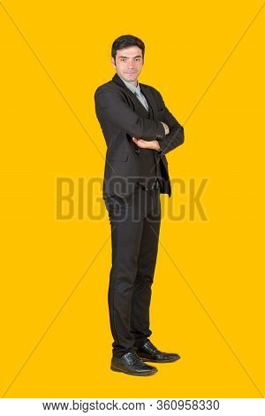 A Young Businessman In A Gray Shirt And A Black Suit Fold His Arms Over The Chest With Confidence. T