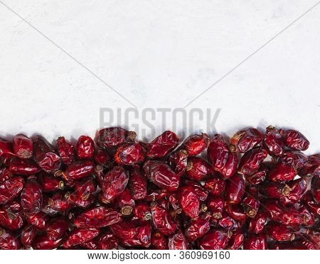 Frame Made Of Dried Rose Hips On White Background