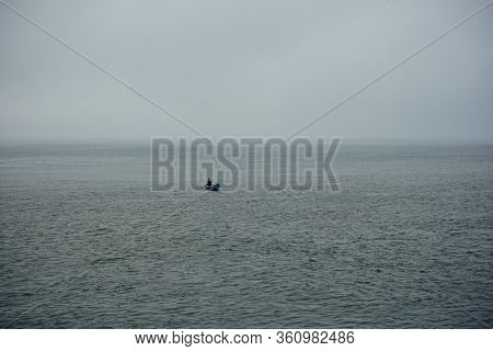 Fisherman In A Small Boat In Atlantic Ocean Near Porto, Portugal