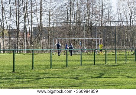 Belgium, Sint Gillis Waas, 24 March 2020, Belgian Police Talking To Two Boys Playing On Preserving S