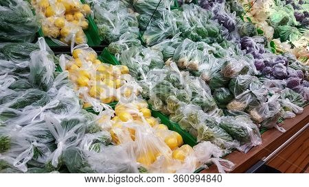 Vegetables Sold In Plastic Bags To Prevent Coronavirus Spread On Supermarket Racks. Protection And P