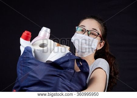 Young Woman In Protective Mask With A Bag Full Of Groceries From The Supermarket
