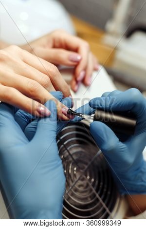 A Girl Is Doing Manicure. A Girl Is Lacquering.