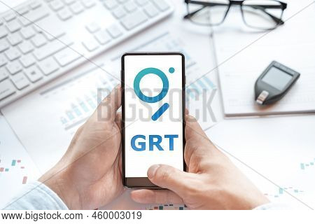 Logo Of Graph Coin In Tablet. Cryptocurrency Grt Token. Trading Blockchain Platform To Buy,sell On D