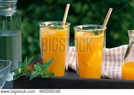 Refreshing Summer Homemade Orange Cocktail In Tall Double Glass Glasses With Mint And Ice, Selective