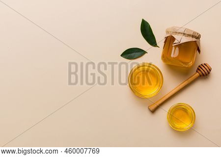 Honey Jar With Wooden Honey Dipper On White Background Top View With Copy Space. Delicious Honey Bot
