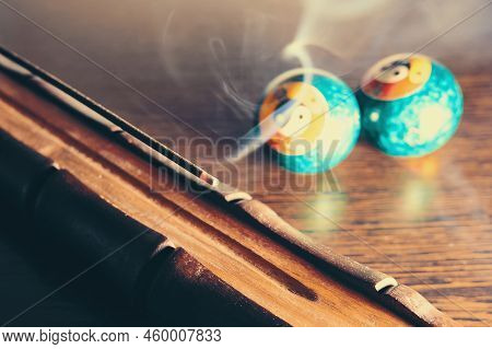 Smoky Incense Stick. Incense Stick With Holder And Baoding Balls On Wooden Table