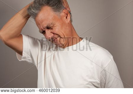 Mature Man 60plus Doing Back Of The Neck Stretches For Back And Neck Pain Relief