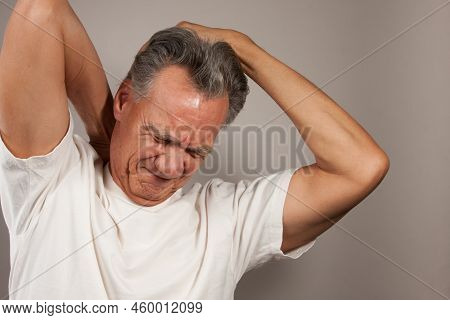 Mature Man 60plus Doing Back Of The Neck Stretches For Back And Neck Pain Relief