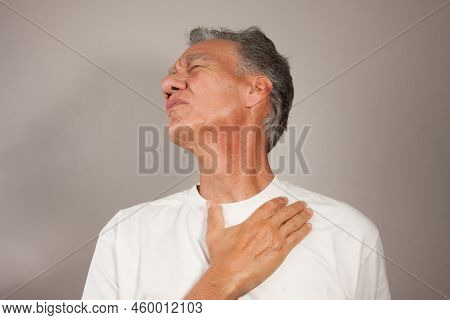 Mature Man 60plus Doing Back Of The Neck Stretches For Back And Neck Pain Relief