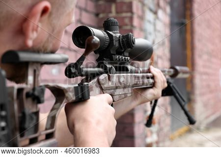 Soldier Holding Modern Powerful Sniper Rifle With Telescopic Sight Outdoors, Closeup