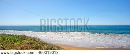 Foam From Backwash From Ocean Waves Breaking Onto A Sandy Beach At Buddina, Queensland.
