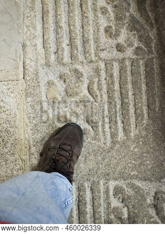 Caceres, Spain - Oct 26th, 2021: Walking Over Tomb Slab On Floor At Church Of San Juan. Caceres, Ext