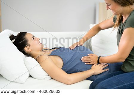 Pregnant Woman Massage By Doula. Baby Care And Pregnancy Service