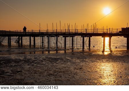 High Quality Photo Of A Pier At Sundown. Wooded Bridge Seaside With Sunset, Strunjan. Slovenia