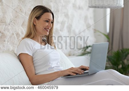 Positive Pretty Woman Using Laptop In Bed, Copy Space