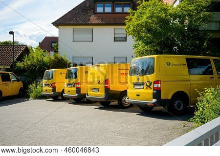 Oberkirch, Germany - May 27, 2022: Row Of Multiple Volkswagen Yellow Vans With Deutsche Post Logotyp