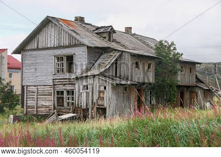Abandoned Wooden House In A High Grass Field