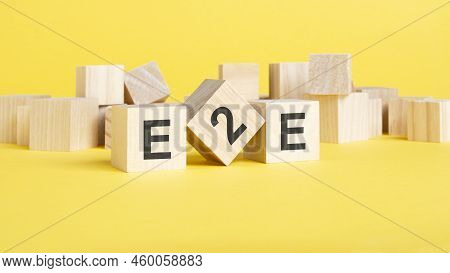 Wooden Blocks With Text E2e On Yellow Background. Exchange To Exchange Concept