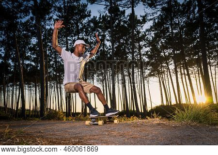 Surf Skater Performing A Slide By The Pine Forest At Sunset In Maceda, Ovar - Portugal.